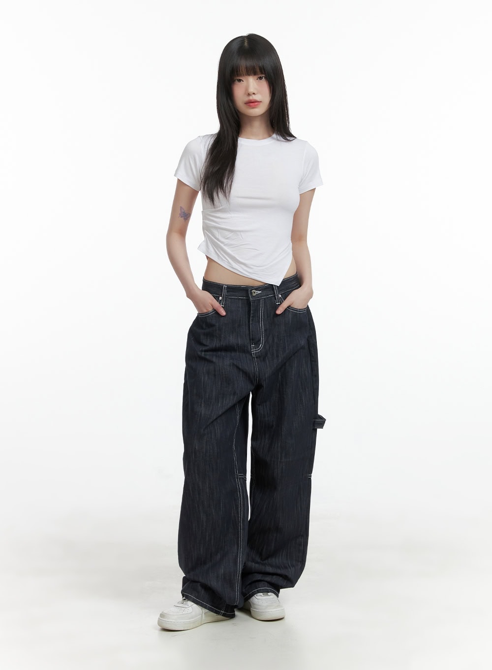 Low-Rise Strap Baggy Jeans CY414 in dark blue, full-body front view on model, oversized baggy fit with low waist, styled with white crop tee and white sneakers.