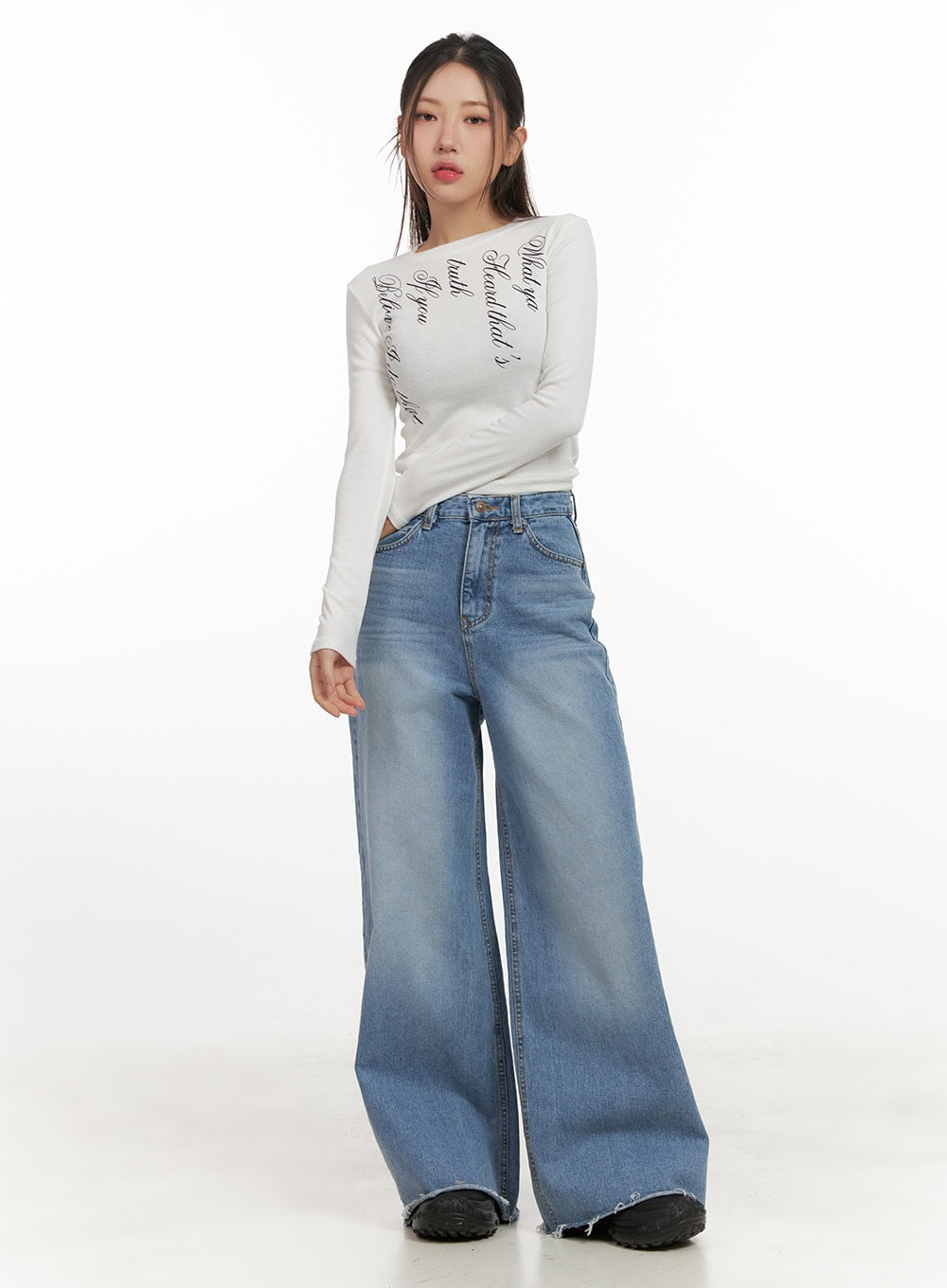 Melody Chic Flare Wide Leg Jeans CN428 in light blue, full-body front view on model, wide-fit washed denim with flare silhouette, paired with white graphic long-sleeve top and black chunky sneakers.