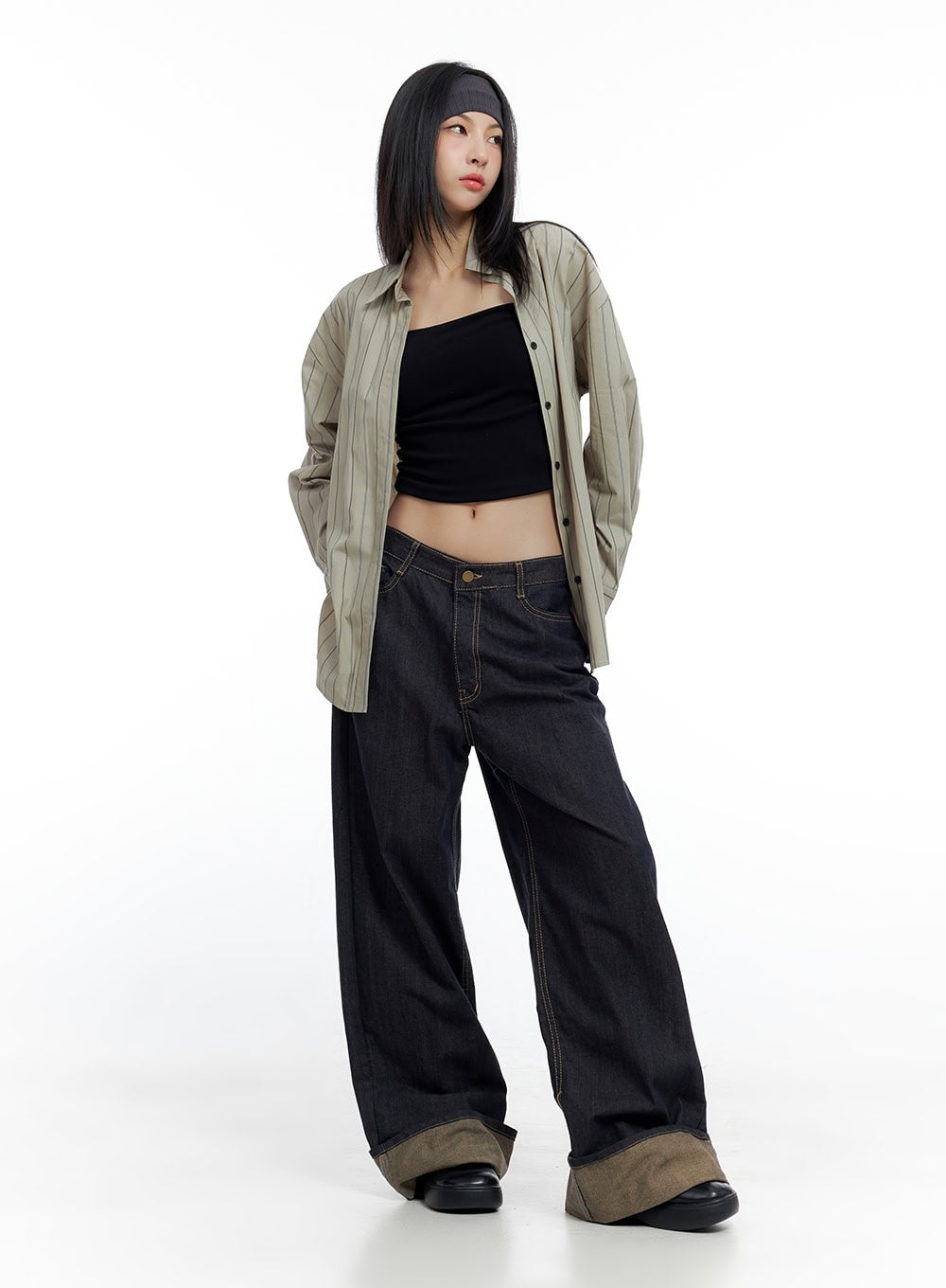 Sadie Roll-Up Denim Jeans CO426 in dark blue, full-body front shot on model, wide-fit baggy denim styled with striped oversized shirt and black crop tube top, roll-up hem visible.