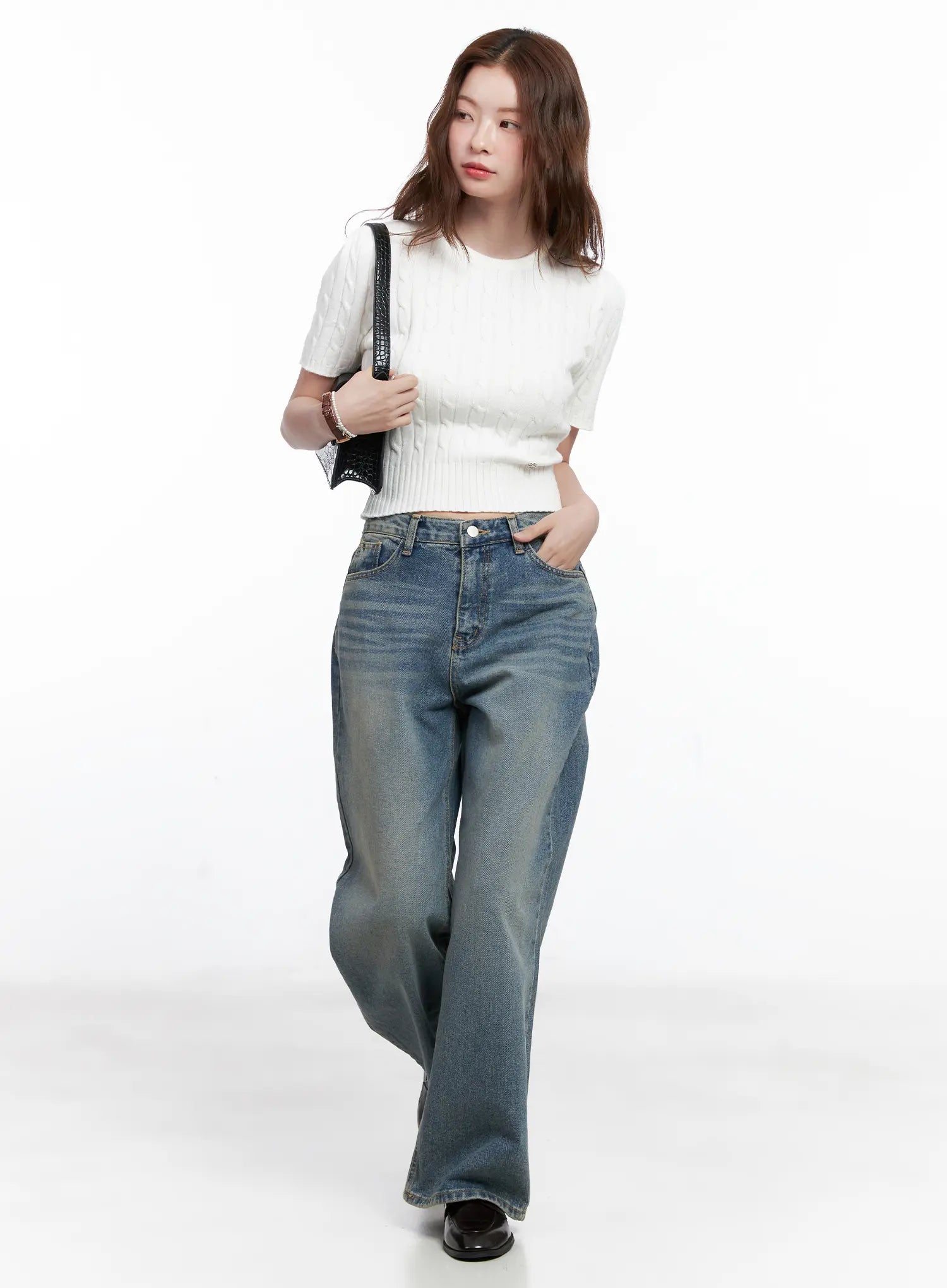 Qu Wide-Leg Vintage Wash Jeans CG521 in blue, full-length editorial shot on model walking, styled with white cable-knit crop top and black clutch, wide-leg silhouette to ankle.