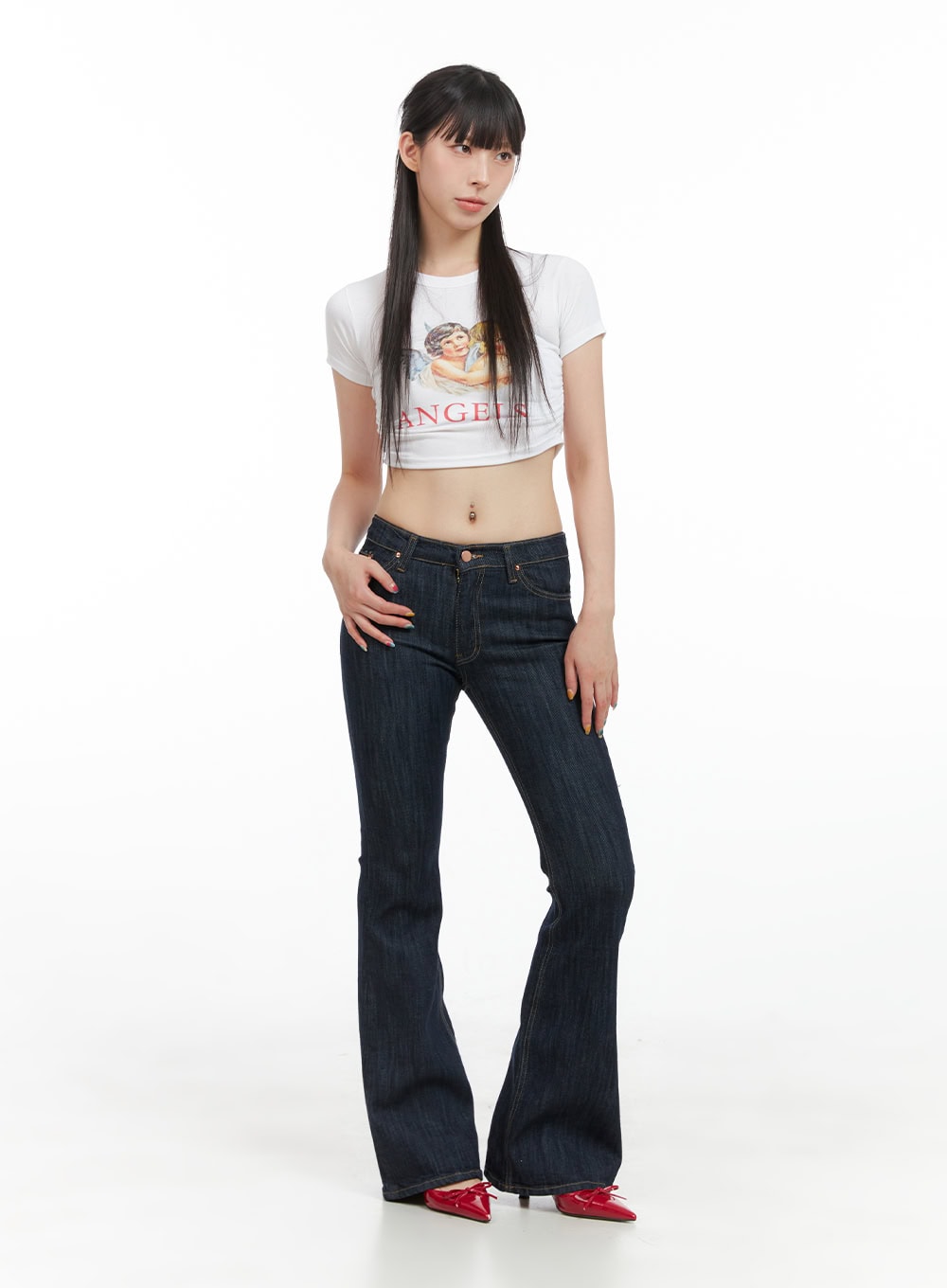 Lila Slim Fit Bootcut Jeans CG409 in dark blue, full-body front shot on model, slim bootcut silhouette with washed denim, paired with white graphic crop tee and red bow heels.