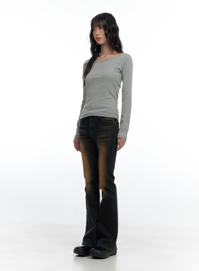 Harley Slim Washed Denim Bootcut Jeans CS420 in Blue, full-body front shot on model, slim bootcut silhouette with rust-tone washed finish, styled with grey long-sleeve top and chunky black shoes.