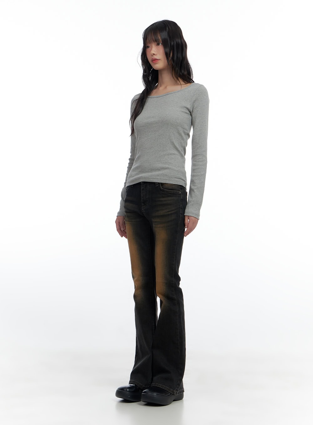 Harley Slim Washed Denim Bootcut Jeans CS420 in Blue, full-body front shot on model, slim bootcut silhouette with rust-tone washed finish, styled with grey long-sleeve top and chunky black shoes.