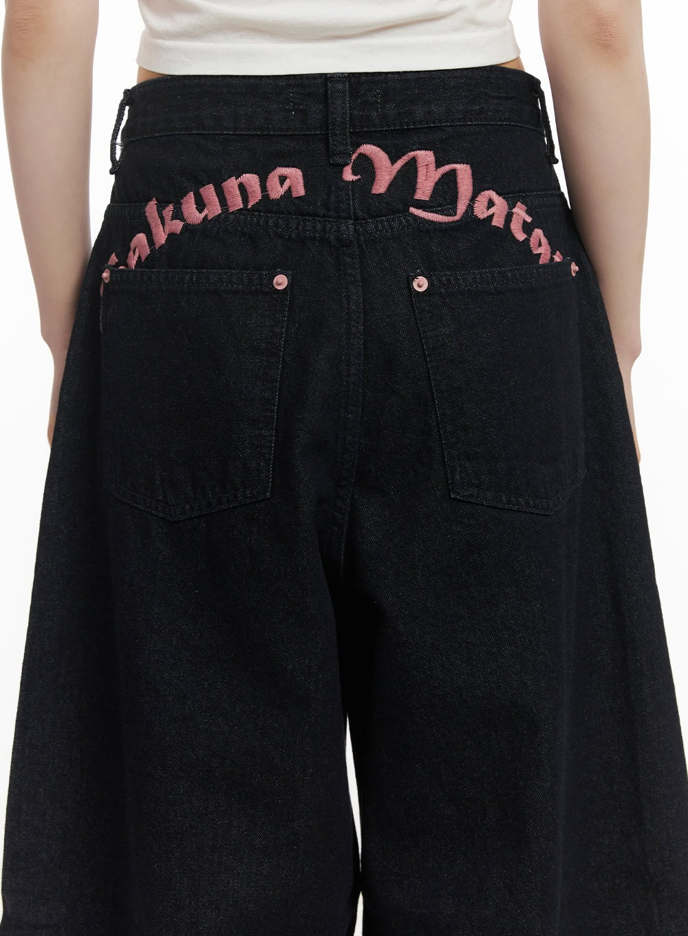 Dory Embroidered Baggy Jeans CF518 in dark blue, back close-up on model showing pink lettering embroidery along waistband and dual back pockets on wide denim.