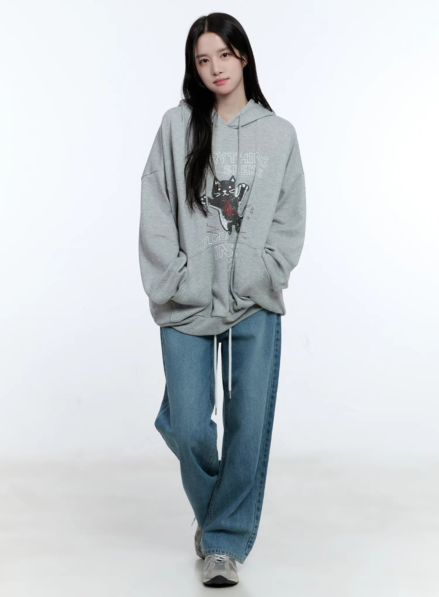 High-Waist Wide-Leg Drawstring Jeans CG513 in blue, full-body front shot on model, wide-fit washed denim with white drawstring, styled with oversized grey graphic hoodie and sneakers.