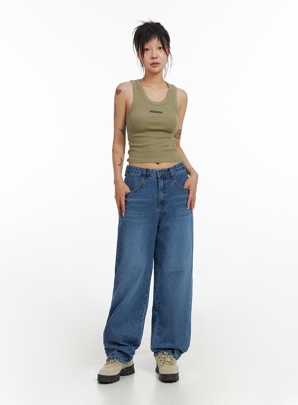 Wide Leg Baggy Jeans CL415 in blue, full-body front shot on model, washed denim wide-leg silhouette, paired with olive crop tank top and chunky lace-up sneakers.
