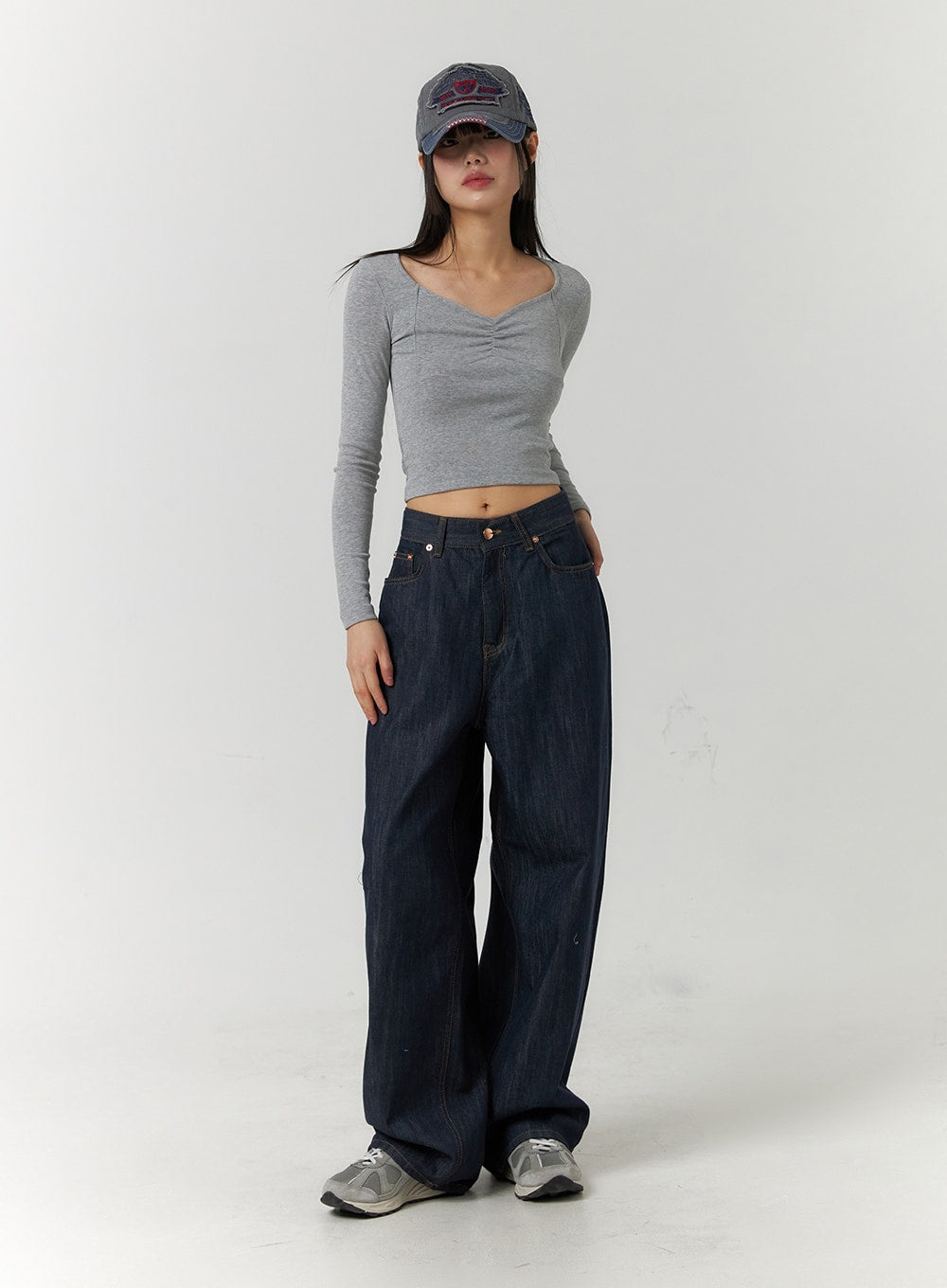Back Button Wide Leg Jeans CF407 in blue, full-body front shot on model, oversized wide-leg dark denim pooling at hem, styled with grey crop top and denim cap.