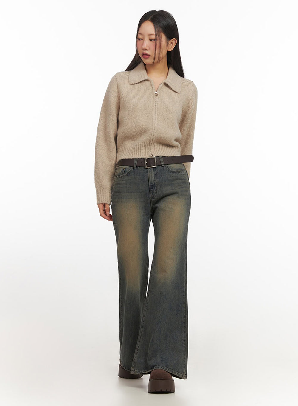 Kourtney Vintage Wash Flared Jeans IF510 in dark blue, full-length front shot on model walking, slim-fit flared denim with golden vintage wash, styled with beige zip-up collar knit and brown leather belt.