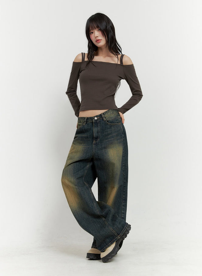 Strap Off-Shoulder Crop Top IO430 in dark brown, full-body front shot on model, crop length ribbed top with double strap off-shoulder neckline, styled with baggy faded jeans and chunky shoes.