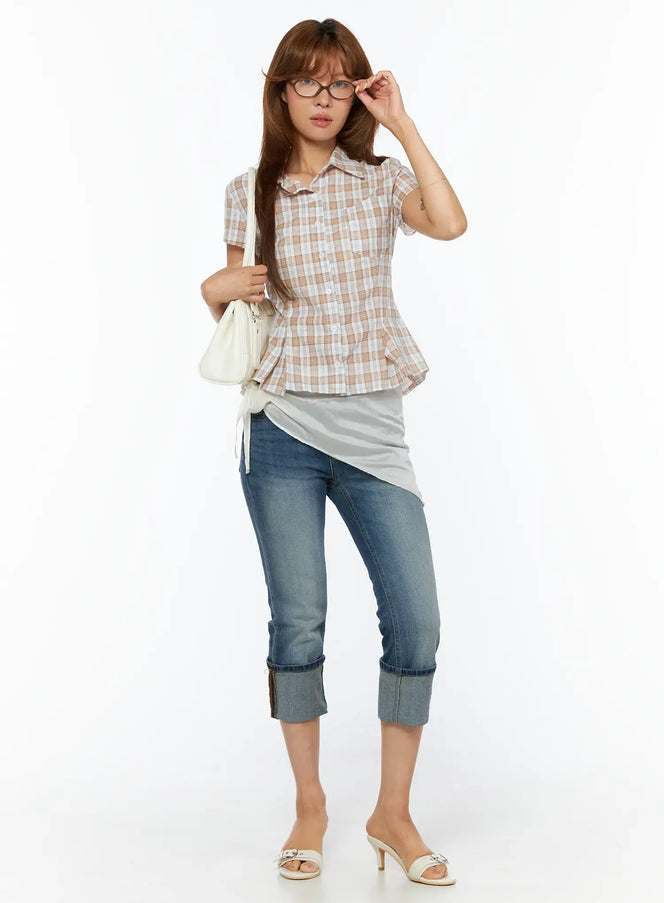 Rena Roll-Up Capri Jeans CU517 in blue, full-body front shot on model, styled with plaid peplum shirt, layered inner top, white mini bag, and heeled mules.