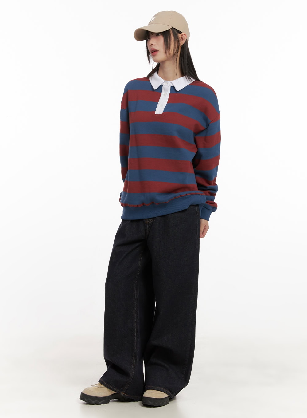 Allie Stitched Wide-Leg Jeans CD430 in dark blue, full-body front view on model, relaxed wide-leg silhouette styled with striped rugby sweatshirt and beige cap.