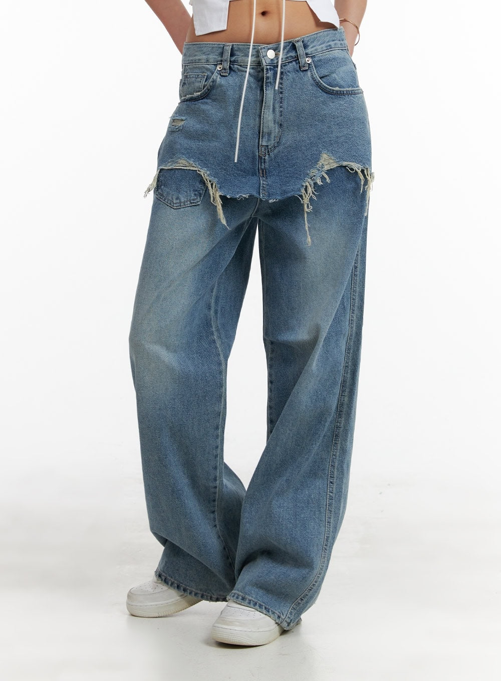 Layered Wide Leg Jeans CA430 in Blue, mid-body front close-up on model, highlighting destroyed raw-hem frayed skirt layer over wide-leg denim, washed blue cotton, 5-pocket construction.