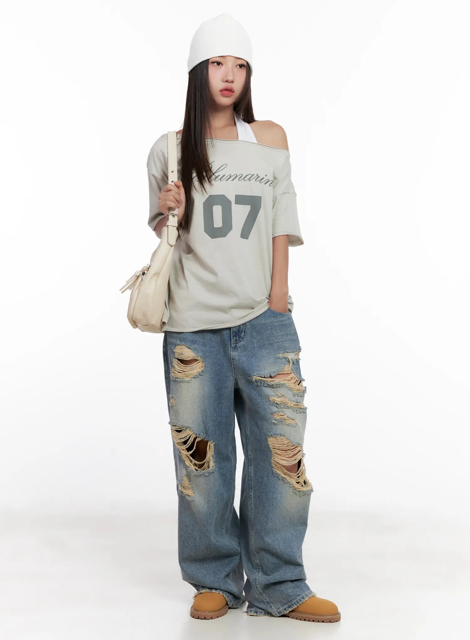 Manon Washed Distressed Wide Jeans CL518 in blue, full-body front worn shot, styled with off-shoulder graphic tee, white beanie, and cream shoulder bag, street hiphop look.