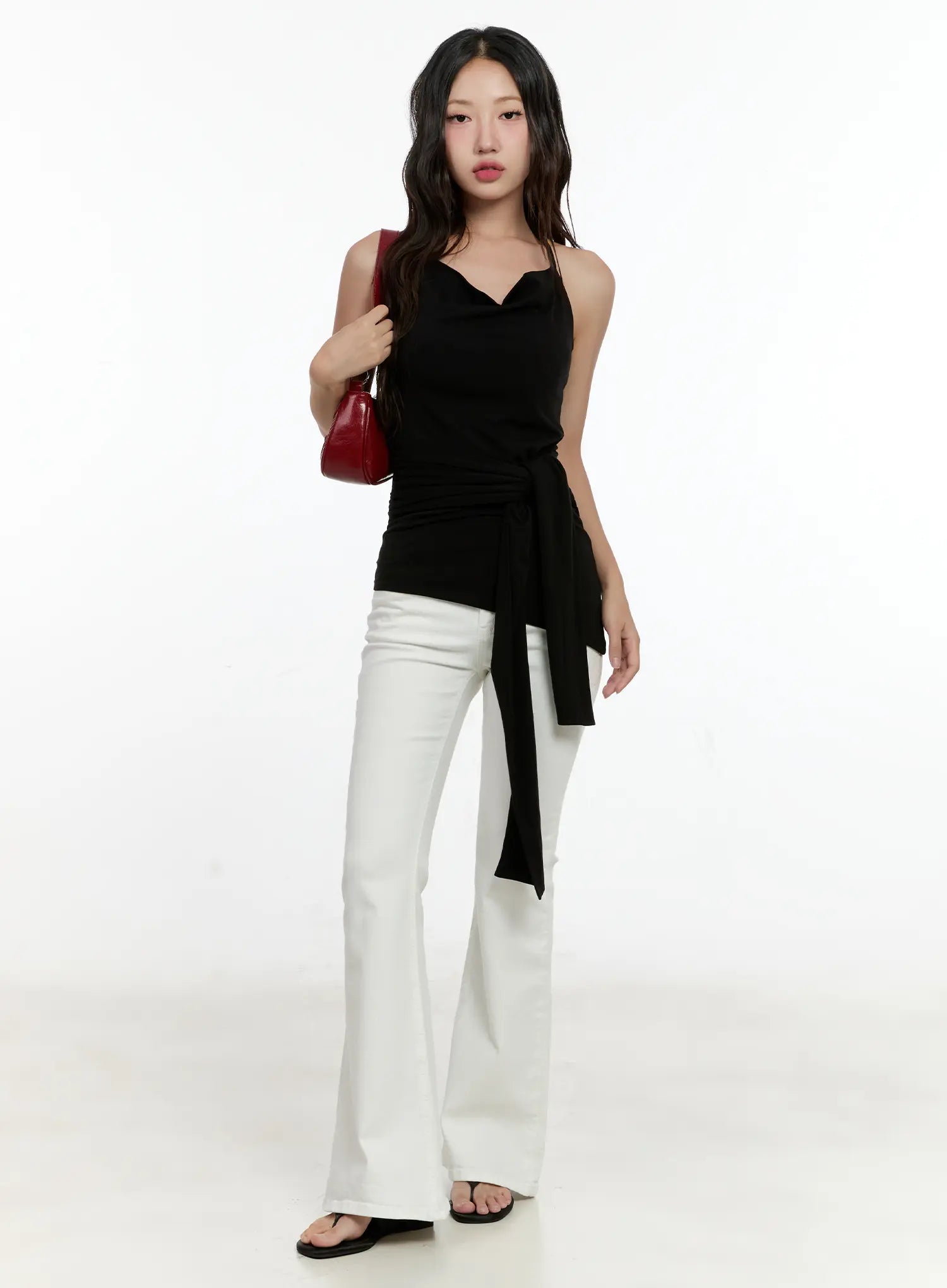 High-Waist Flare Pants CG501 in white, full-body front shot on model, paired with black halter tie top and red mini bag, long flare silhouette.