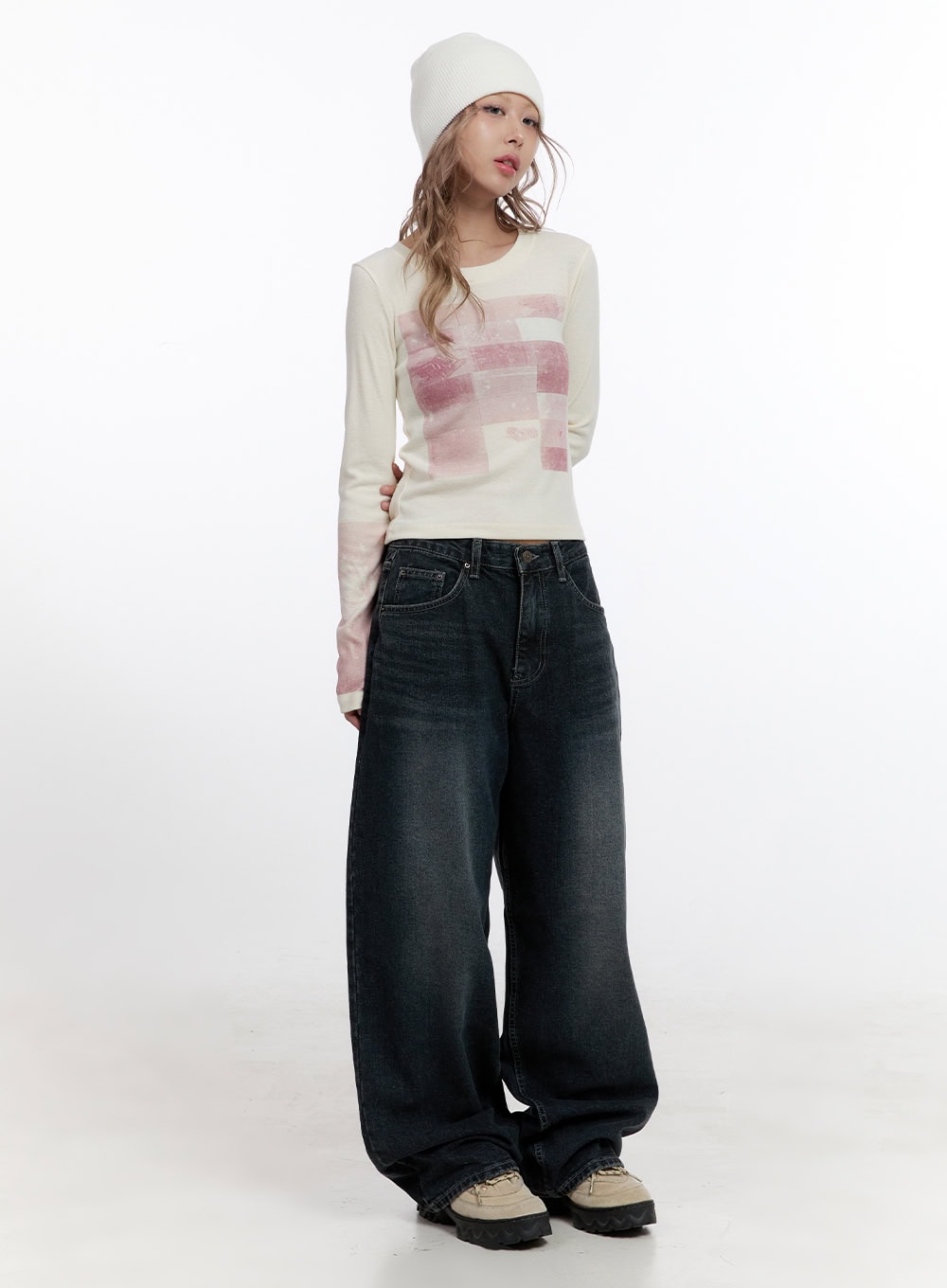 Camila Washed Cotton Jeans CN422 in dark blue, full-body front shot on model, wide baggy washed denim styled with cream graphic long sleeve and white beanie, chunky sneakers.