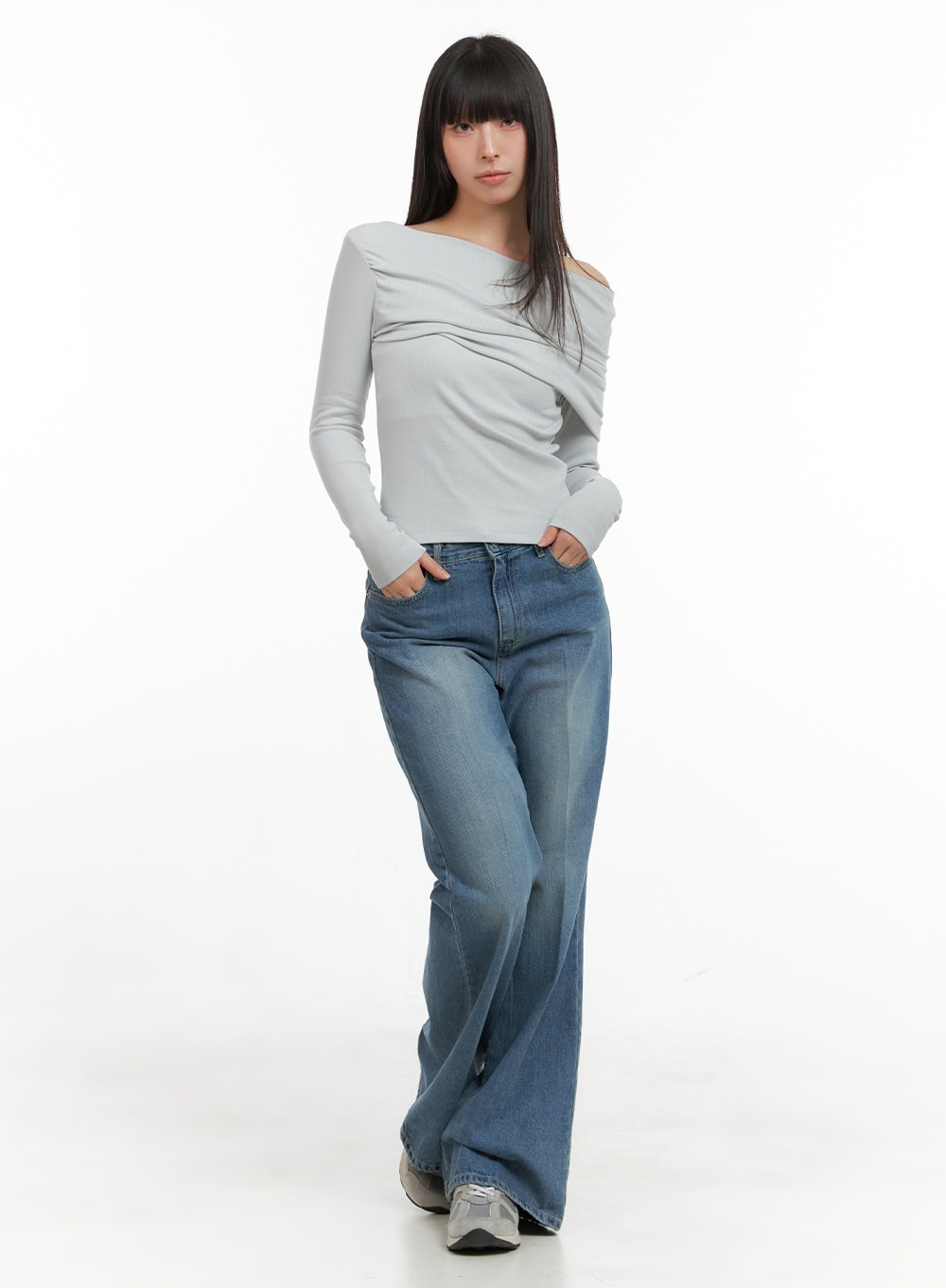 Daisy Loose Fit Bootcut Jeans CG419 in blue, full-body front shot on model, wide bootcut washed denim, styled with grey off-shoulder long-sleeve top and sneakers.