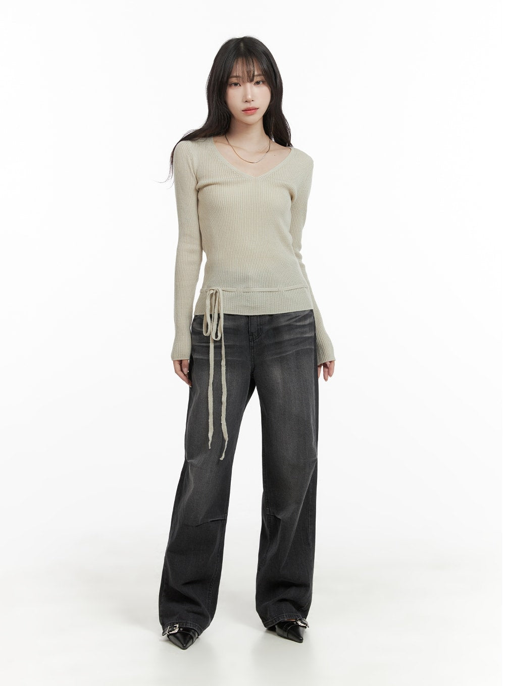 Pintuck Washed Wide Leg Jeans CA403 in Black, full-body front shot on model, relaxed wide leg washed denim, styled with beige V-neck drawstring knit top and black pointed-toe buckle shoes.