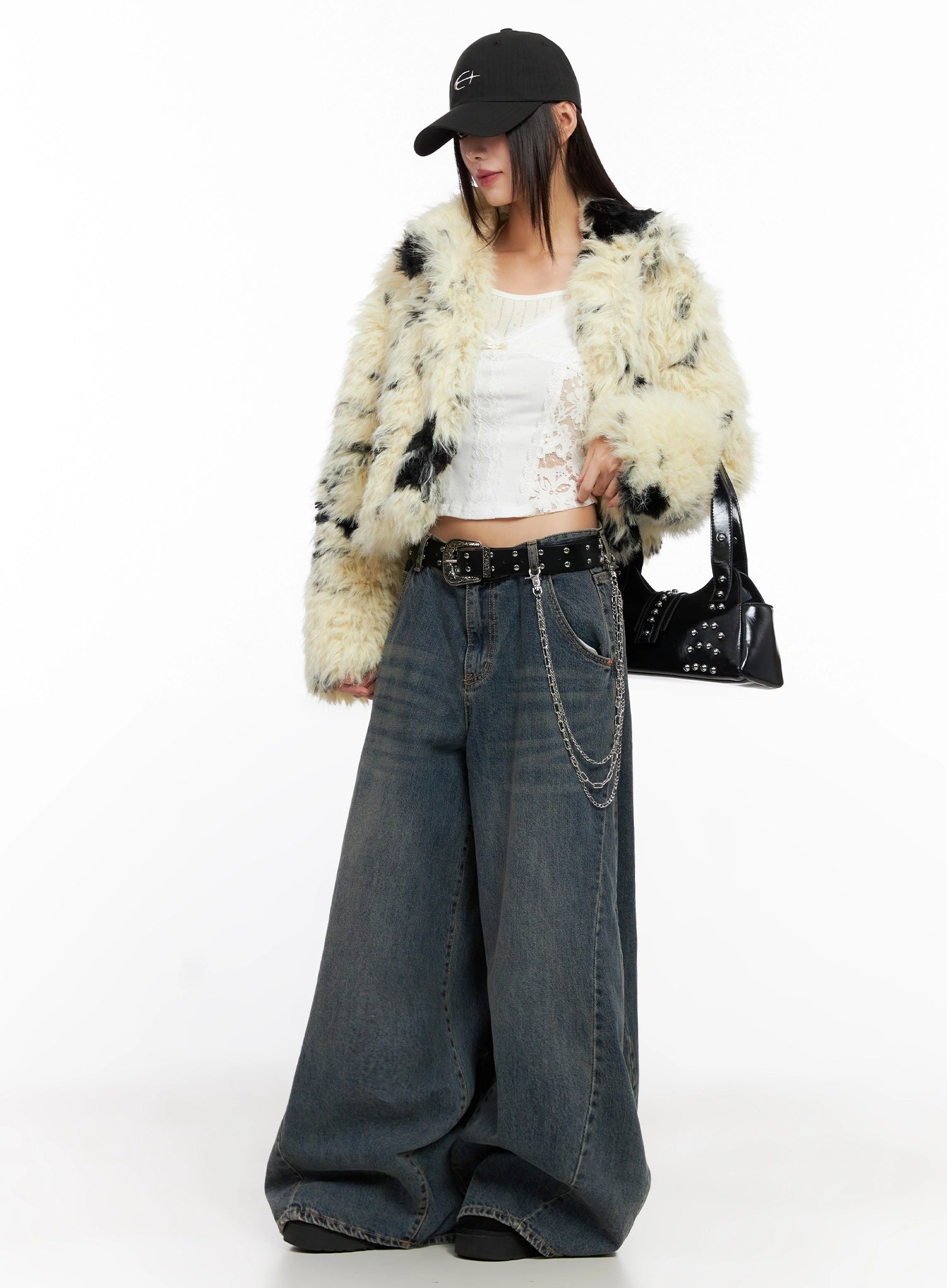 Skyler Washed Balloon Fit Jeans IN503 in blue, full-body editorial shot, model wearing faux-fur coat and chain belt, extreme wide-leg washed denim pools at feet, street Acubi style.
