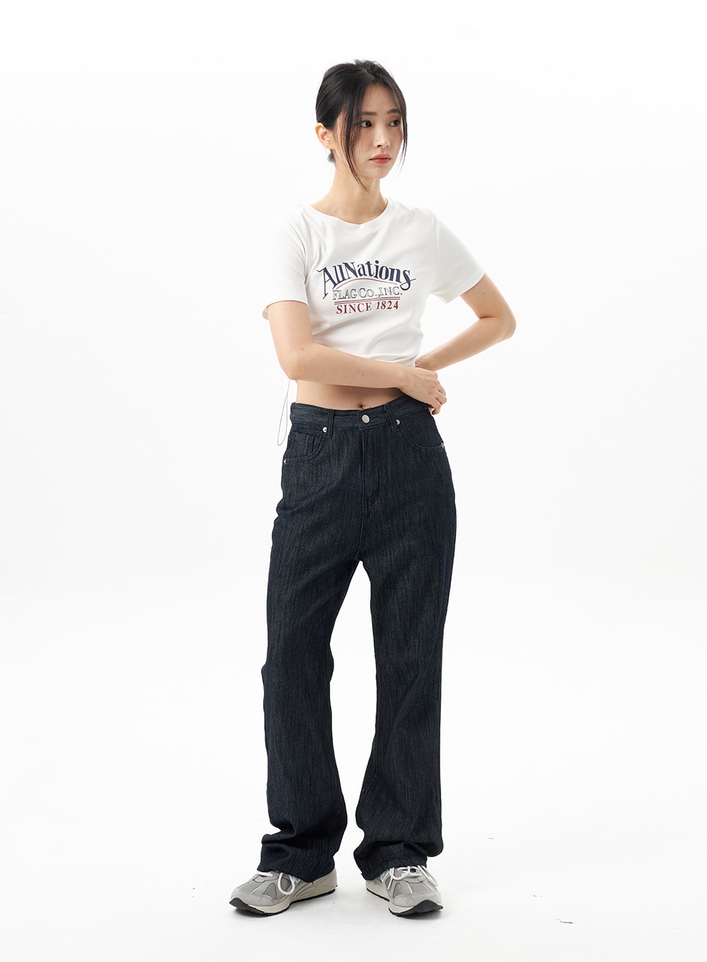 Dark Wash Mid-Rise Jeans OU314 in dark blue, front full-body shot on model standing straight, bootcut silhouette with front pockets, styled with white graphic crop tee.