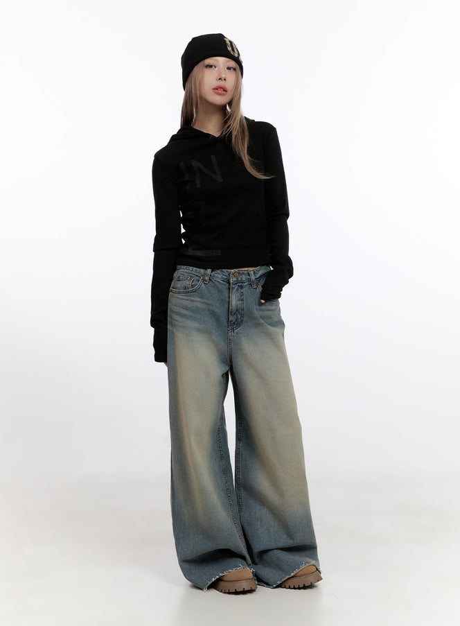 Felicia Cotton Wide Fit Baggy Jeans CN425 in blue, full-body front on model, petite fit, washed wide-leg denim pooling at floor, styled with black cropped hoodie and black beanie.