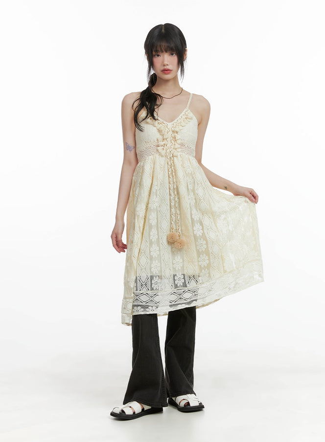 Vintage Washed Bootcut Jeans CA412 in black, full-length styling shot, worn under cream lace cami dress on model, bootcut silhouette visible at hem with white sandals.