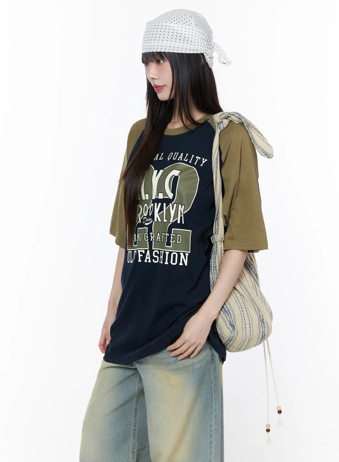 Polka Dot Head Scarf CU519 in White, side-angle full-body shot on model wearing scarf tied at back, paired with graphic tee, wide-leg jeans, and striped drawstring shoulder bag.