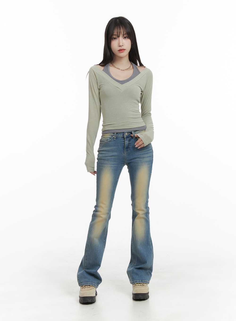 Slim Fit Washed Bootcut Jeans CA402 in blue, full-length front shot on model, slim bootcut silhouette with yellow wash fade, styled with sage green layered long-sleeve top and chunky boots.