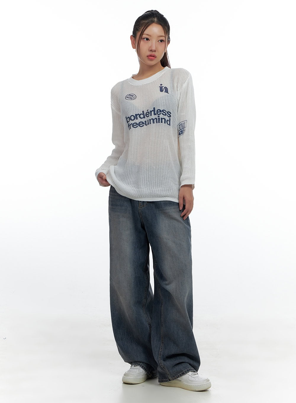 Lana Oversized Wide-Leg Jeans CS425 in blue, full-body front view on model, washed wide-leg denim with relaxed fit, styled with a graphic ribbed knit top and white sneakers.
