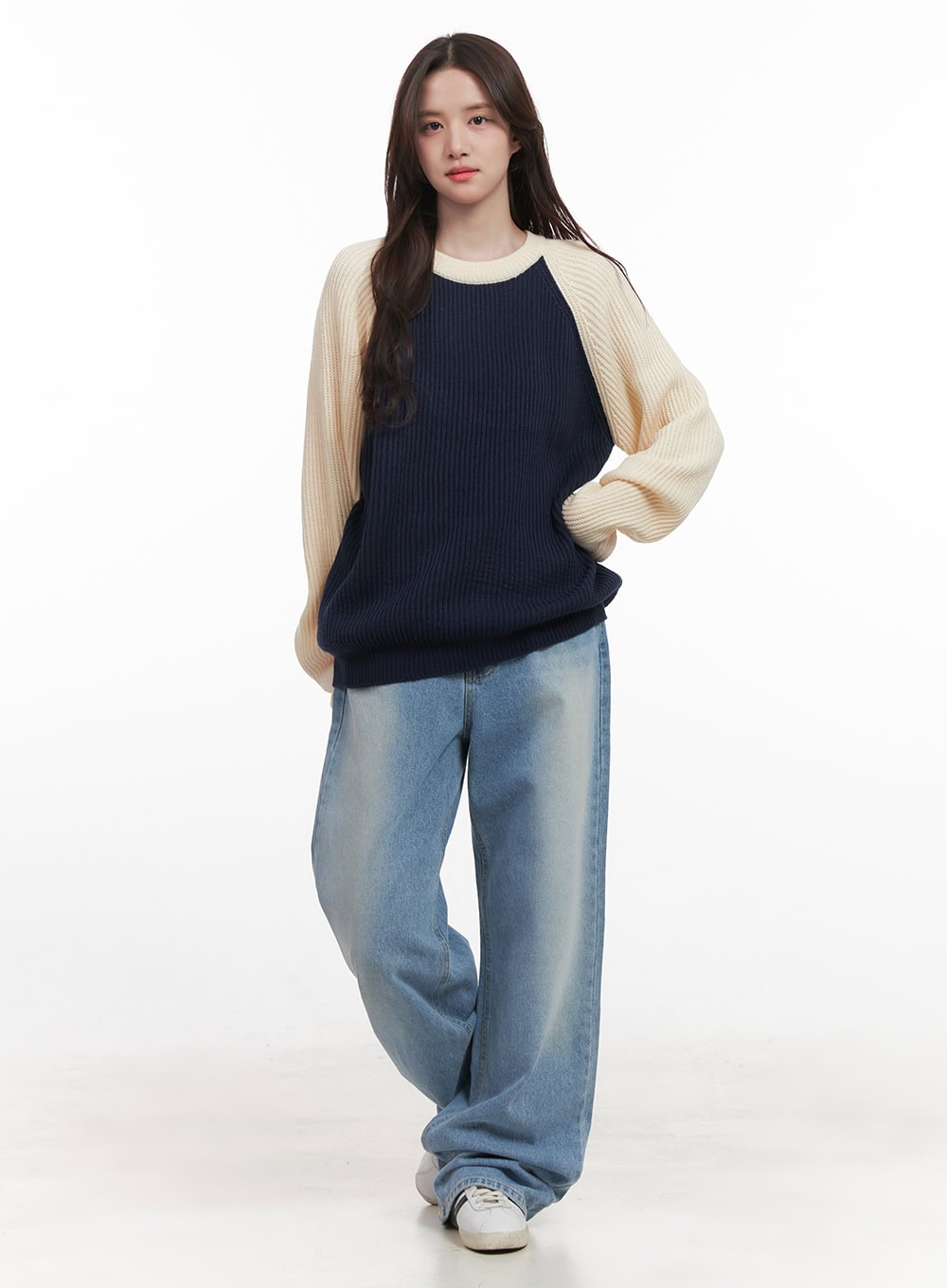 Kelly Washed Baggy Jeans CJ514 in light blue, three-quarter front on model, paired with navy-cream colorblock knit sweater, wide-fit washed denim with relaxed silhouette.