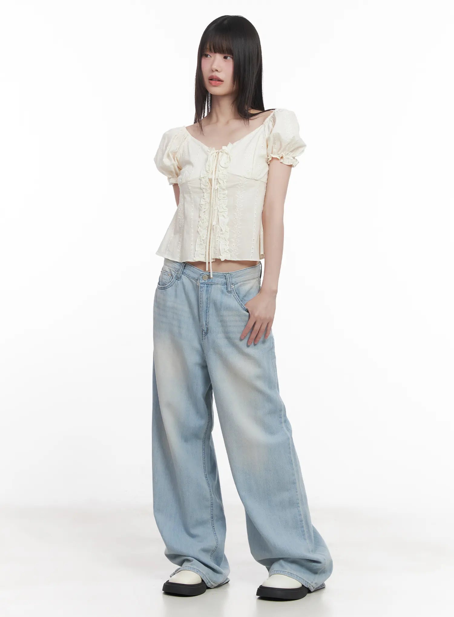 Garam Washed Wide-Leg Jeans CU518 in light blue, full-body front shot on model, relaxed wide-leg silhouette styled with cream puff-sleeve lace-up top and white sneakers.