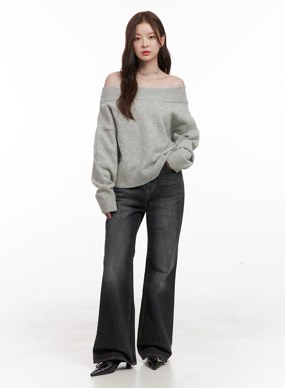 Kiana Cotton Wide Fit Flared Jeans OD403 in black, full-length front view on model, washed wide-fit flared denim, styled with grey off-shoulder knit sweater and black buckle heels.