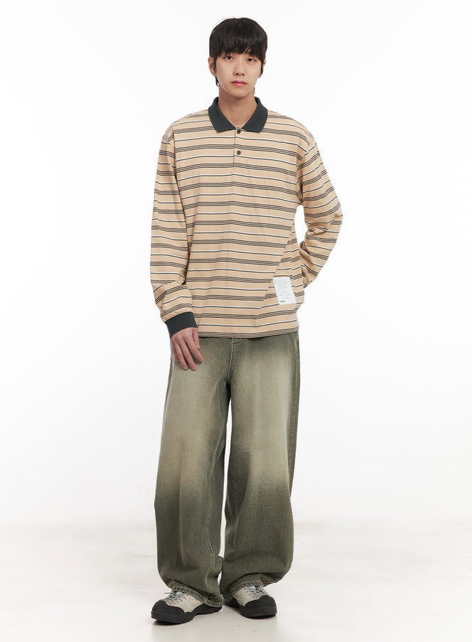Men's Striped Collared Polo Shirt IM519 in beige, full-body front shot on model, relaxed oversize fit with dark stripe pattern, styled with olive gradient wide-leg jeans and chunky sneakers.