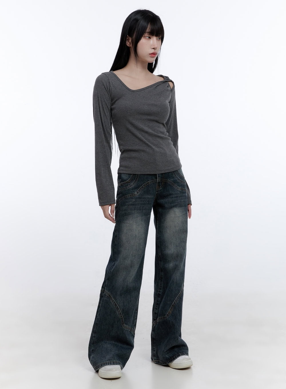 Barbara Washed Wide Leg Jeans CD420 in blue, full-length front shot on model, wide fit washed denim with curved stitch detailing, styled with grey asymmetric cutout long sleeve top and white sneakers.