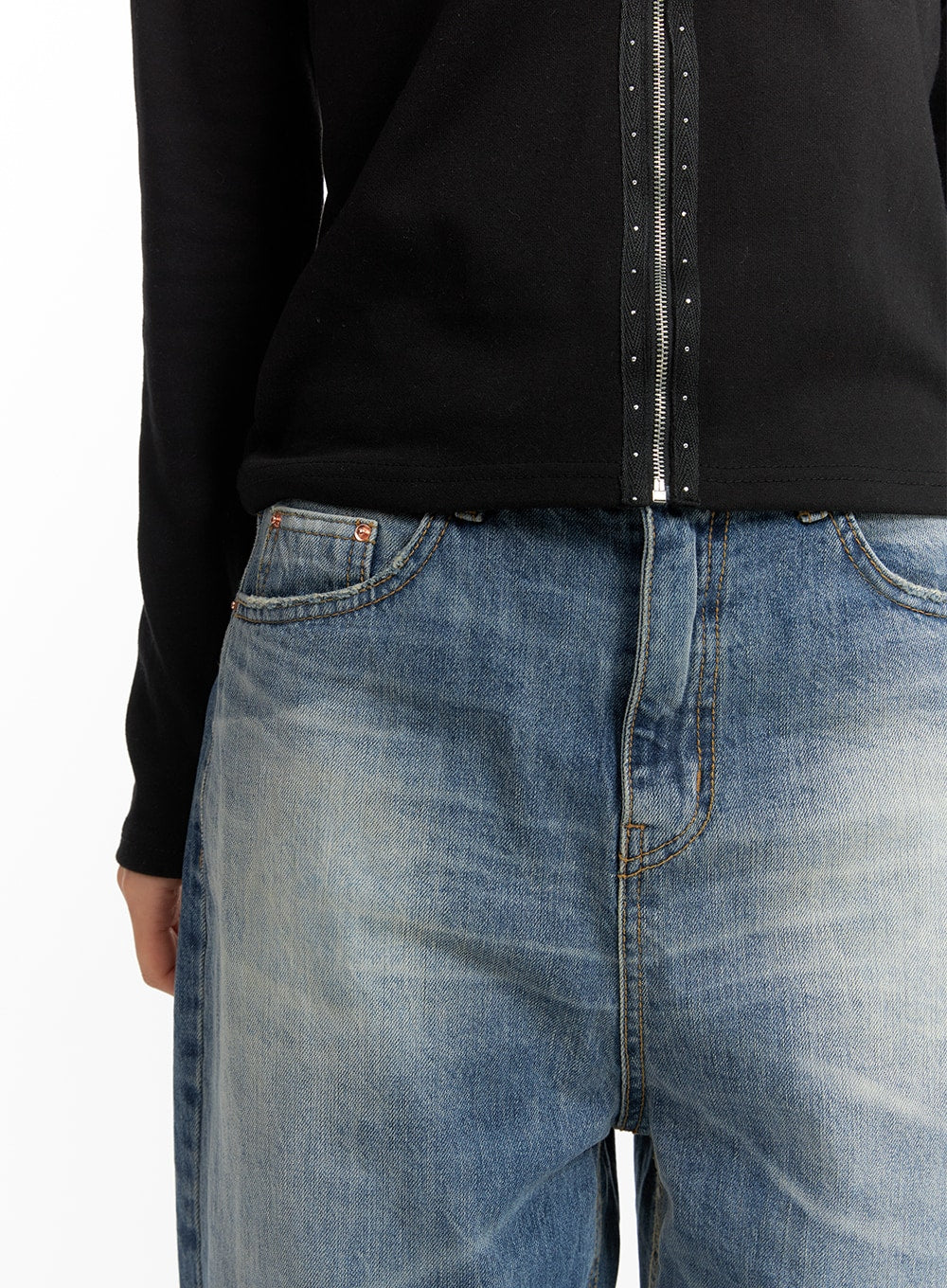 Wide Washed Denim Jeans CF419 in blue, waist close-up on model, five-pocket styling with copper hardware and faded wash detail, styled with black zip hoodie.