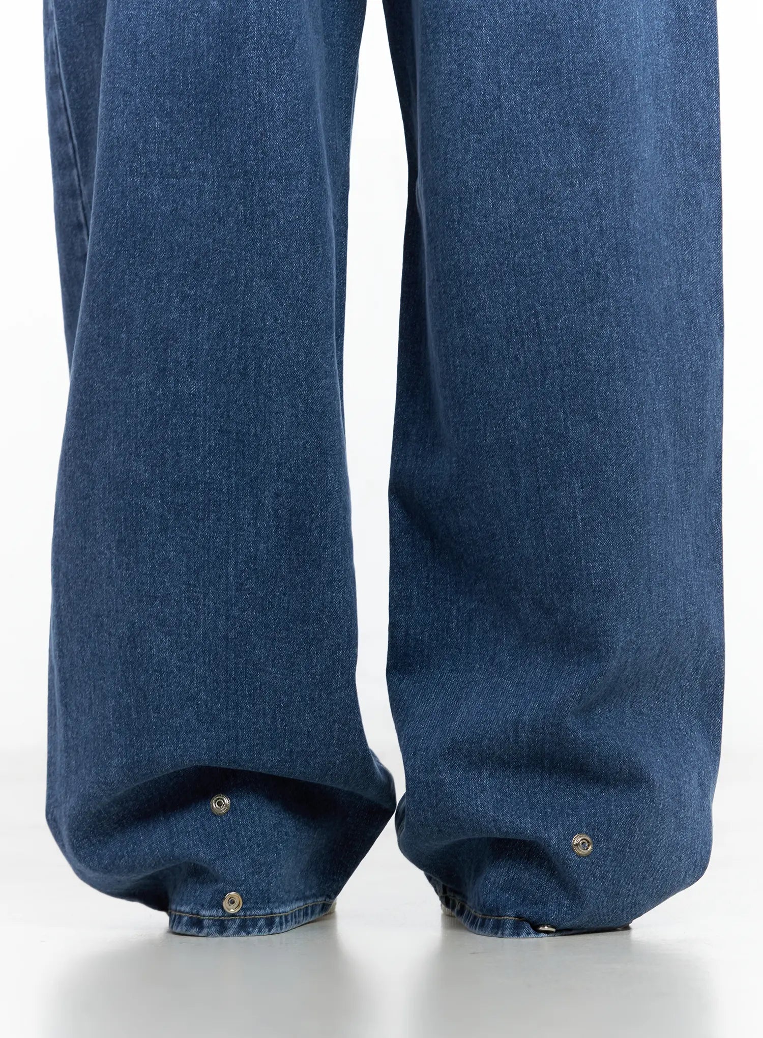 Hayoung Washed Wide-Leg Denim Jeans CL509 in dark blue, close-up of hem detail showing metal snap buttons at wide leg opening, cotton denim texture visible.
