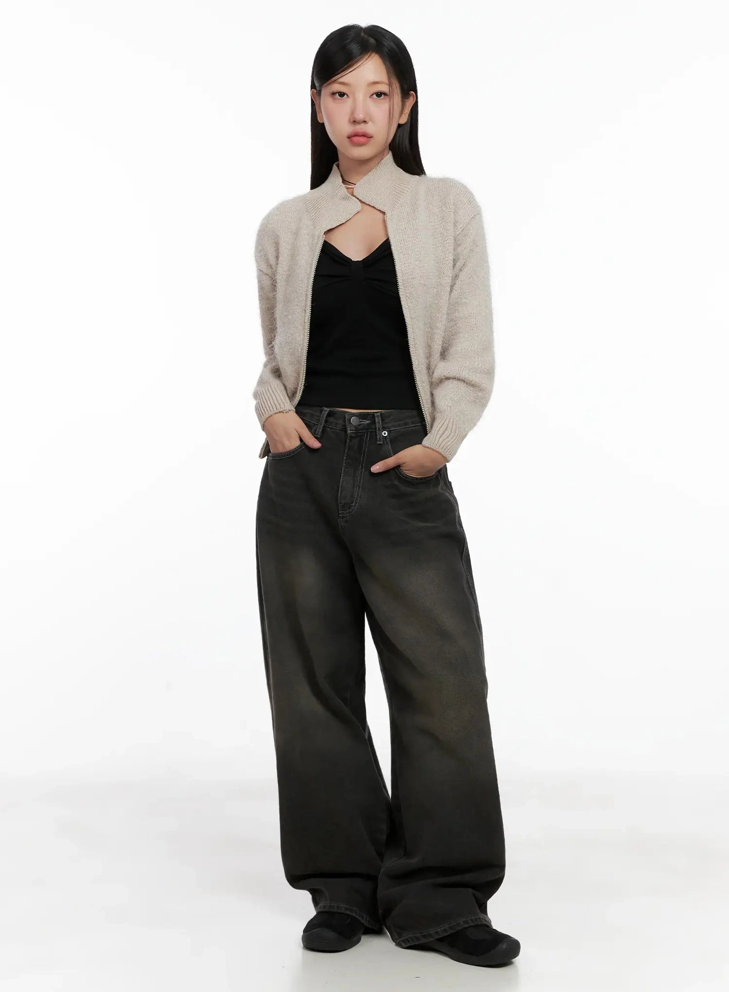 Hari Dark Washed Baggy Jeans IG527 in dark grey, full-length front shot on model, wide baggy silhouette paired with beige knit cardigan and black halter crop top, hands in pockets.