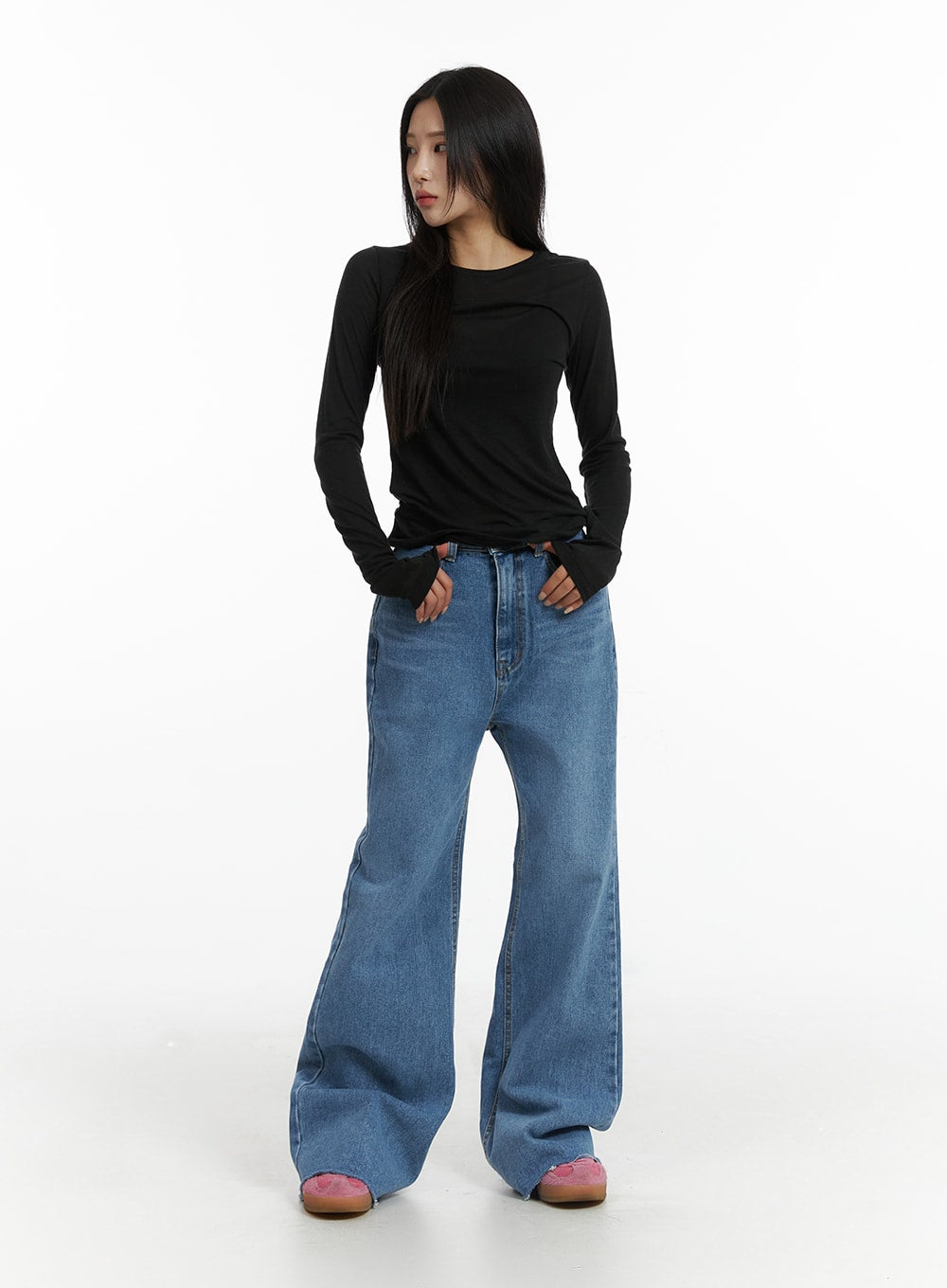 Blue Denim Bootcut Jeans CJ431 in blue, full-length front shot on model, slim high-rise fit with wide flare leg, washed denim, styled with fitted black long sleeve and pink mules.