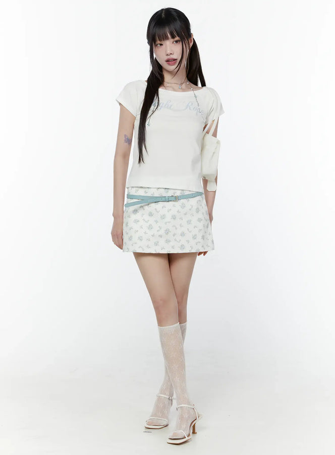 Vintage Floral Print Mini Skirt CU508 in Flower, full-length front on model, paired with white graphic tee, light blue belt, lace knee socks and white heeled sandals, romantic spring styling.