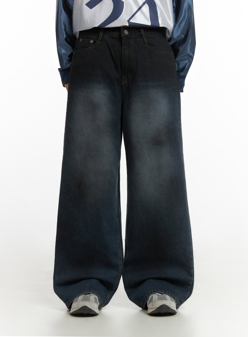 Imogen WashedSky Loose-Fit Denim IO409 in dark blue, front close-up waist-to-hem on model, wide-fit washed denim with faded whisker detailing, paired with sporty jersey top.