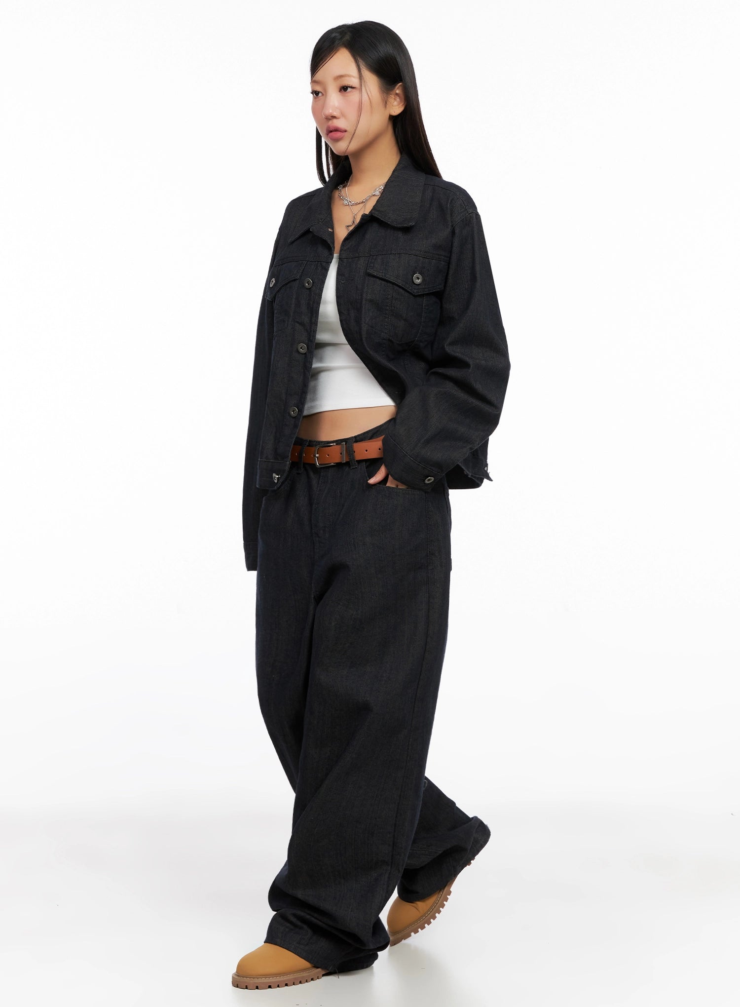 Heidi Wide-Leg Jeans IG527 in dark blue, 3/4 angle full-body on model, styled with matching dark denim jacket, white crop top, brown belt, and tan boots.