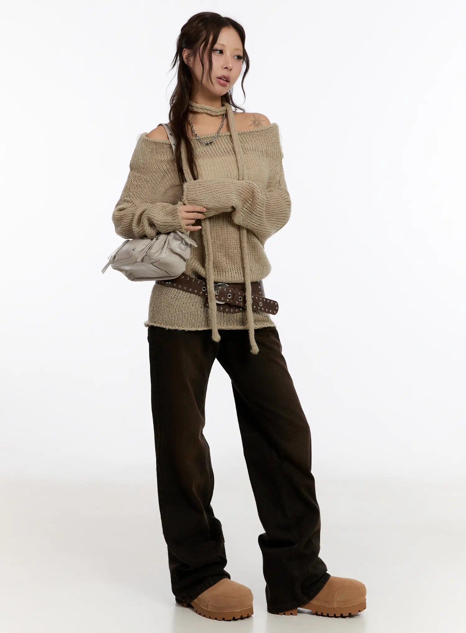 Mael Low Rise Straight Jeans CN527 in black, full-body front shot on model, styled with beige off-shoulder knit sweater, brown eyelet belt, and silver mini bag.