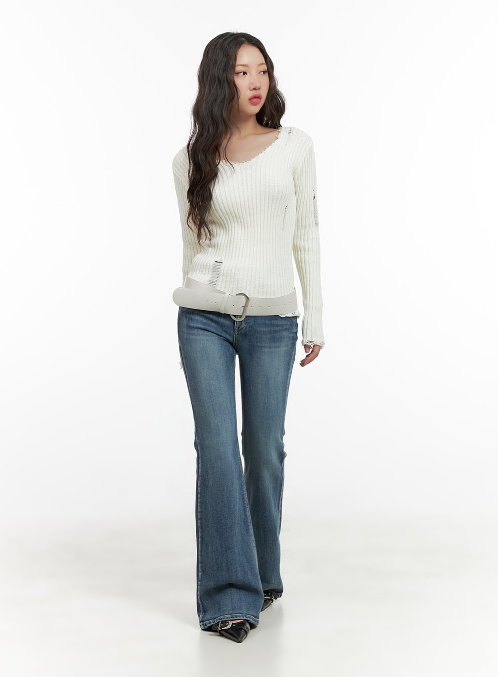 Lila Slim Bootcut Jeans CG422 in blue, full-body front shot on model, slim fit washed denim with flared hem, styled with white distressed ribbed knit and white belt.