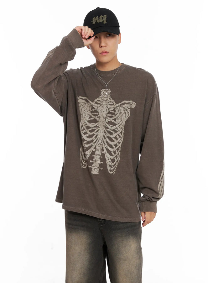 Men's NY Distressed Cap IG529 in black, worn by model touching brim, distressed cotton twill, olive NY embroidery, paired with skeleton-print brown long sleeve and jeans.