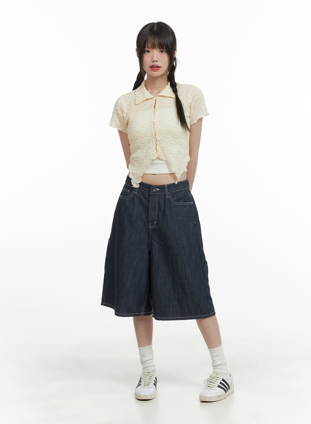Solid Wide-Leg Bermuda Jorts CY414 in dark blue, full-body front on model, wide-fit midi cotton denim paired with cream textured crop top and Adidas sneakers.