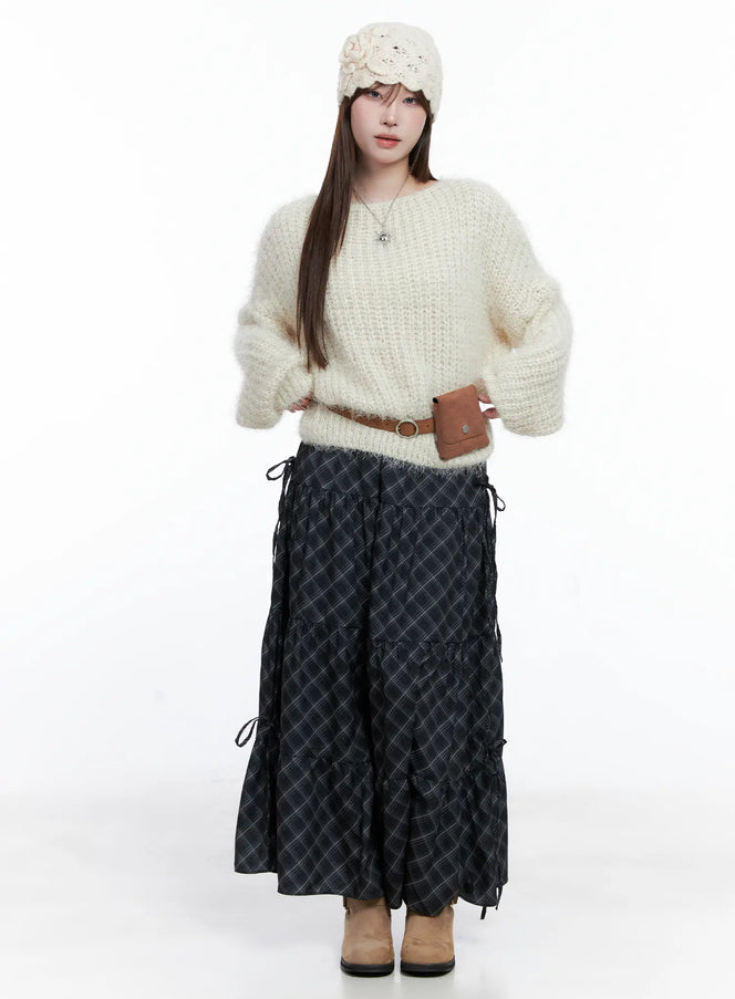 Plaid Maxi Skirt with Ribbon Details CG529 in black, full-body front on model styled with cream mohair sweater, brown belt bag, floral headband, and tan boots.
