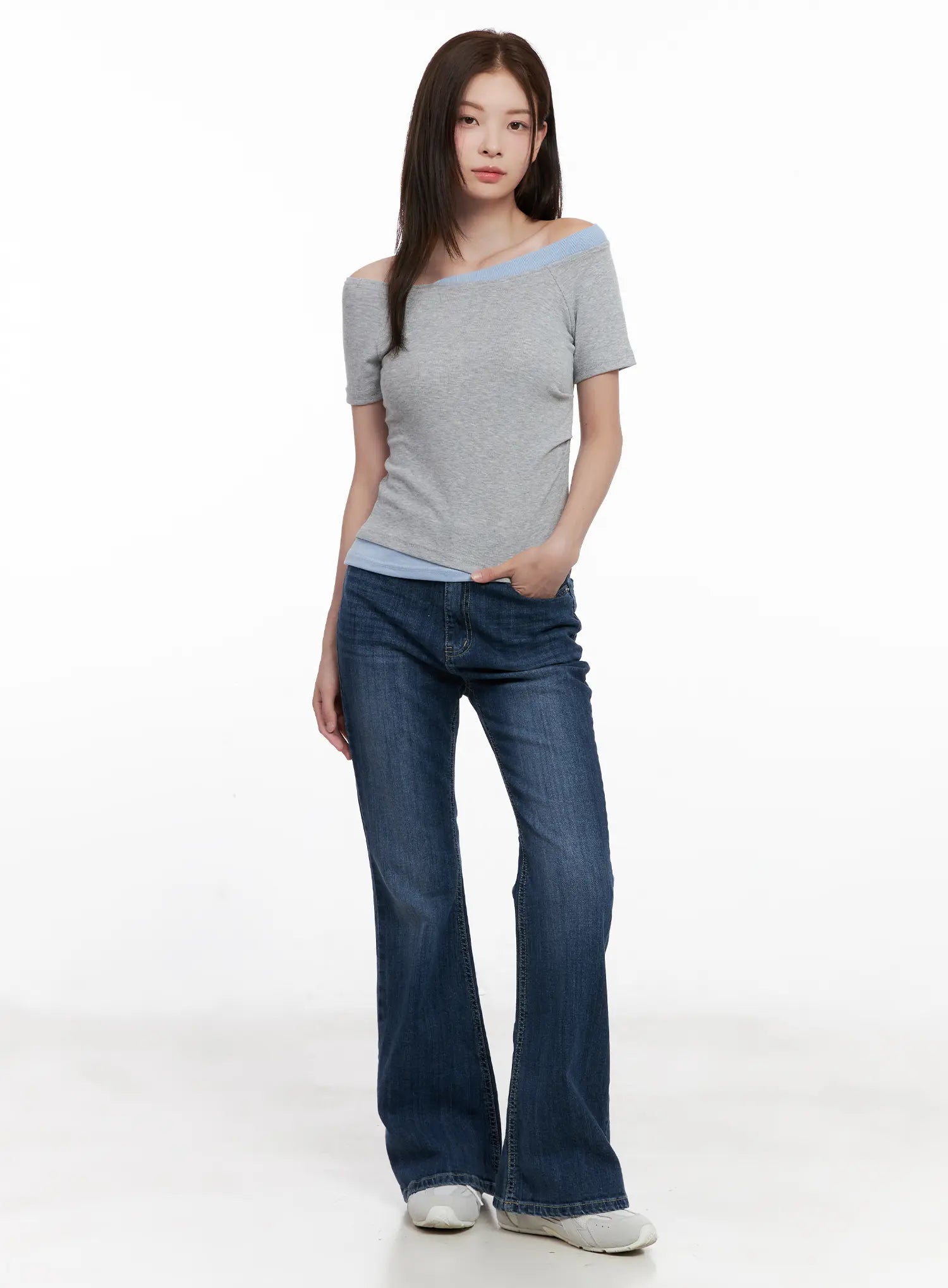 Solhee Classic Flare Denim Jeans CL524 in dark blue, full-body front shot on model, long flare leg silhouette styled with a grey off-shoulder top and white sneakers.