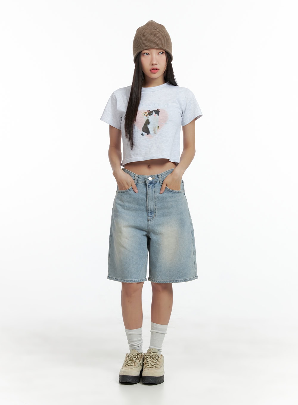 Light Washed Jorts CL417 in light blue, full-body front shot on model wearing brown beanie and graphic crop tee, wide-fit denim shorts with light washed pattern, street acubi style.