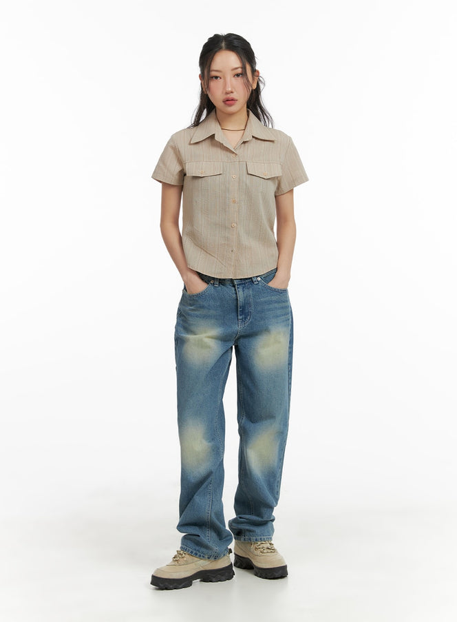 Recycled Washed Jeans (Unisex) CM425 in blue, full-body front view on female model, straight fit with yellow-toned wash, paired with beige cropped shirt and chunky sneakers.