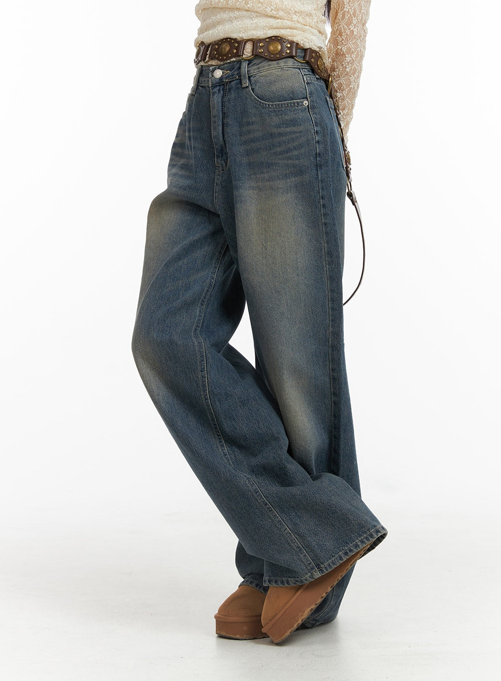 Wide Leg Denim Trousers CJ415 in washed blue, side view on model, wide-leg silhouette with faded wash and relaxed drape, styled with boho studded belt.
