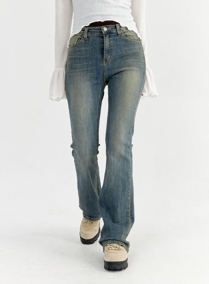 Slim Washed Bootcut Jeans CO327 in dark blue, front waist-to-hem close-up on model walking, vintage washed denim with slim thigh and flared bootcut leg, five-pocket styling.